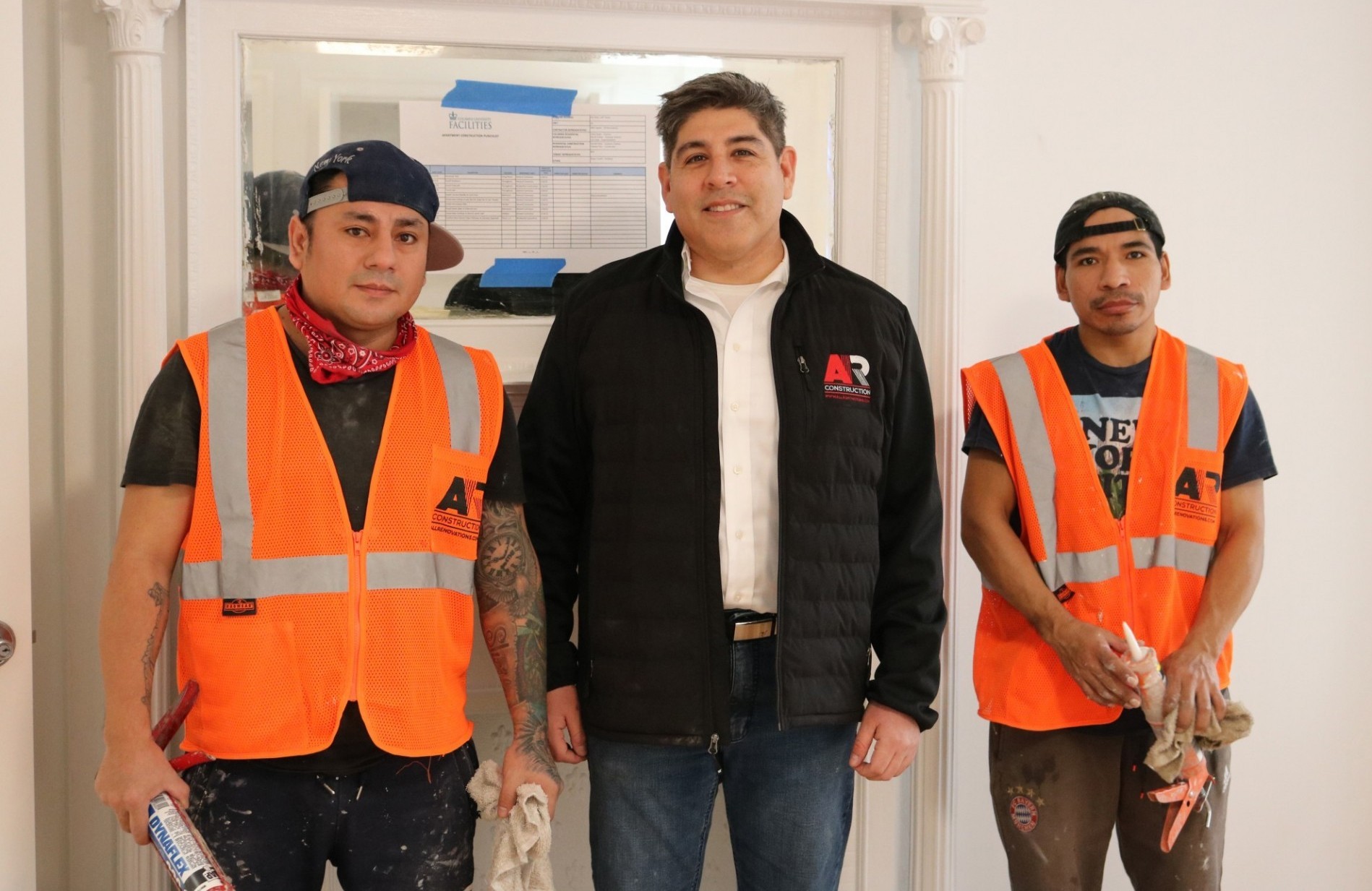 Allan Suarez (middle), chief operations officer at AR Construction, with his team members at a faculty apartment that was recently renovated.