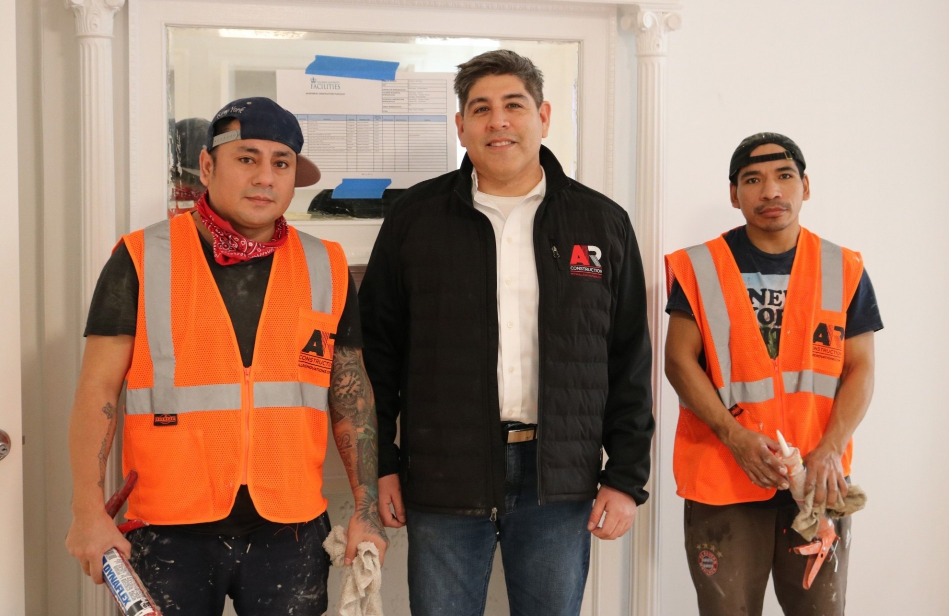 Allan Suarez (middle), chief operations officer at AR Construction, with his team members at a faculty apartment that was recently renovated. Allan Suarez (middle), chief operations officer at AR Construction, with his team members at a faculty apartment that was recently renovated.