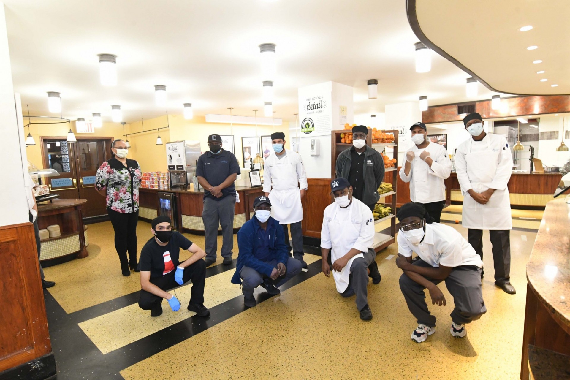 A group of Columbia Dining employees gather around in John Jay Dining Hall.