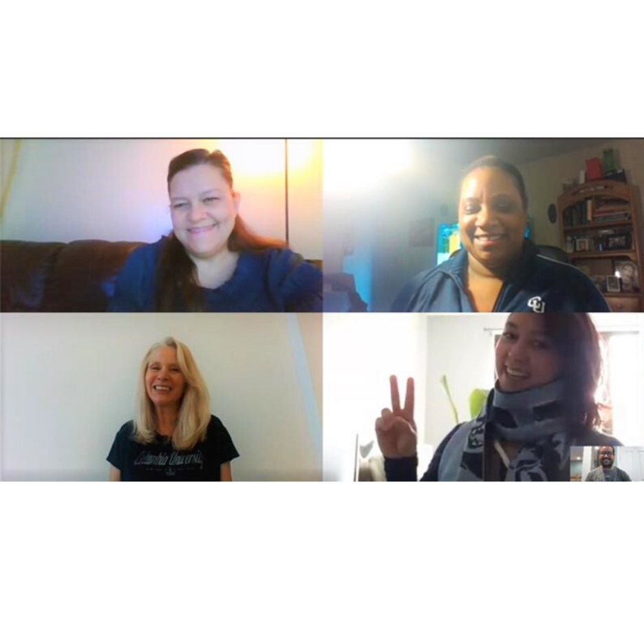A screenshot of a video conference call showing five people smiling at the camera