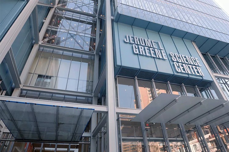 The light blue and glass facade of the Jerome L. Greene Science Center with the building name in white lettering.