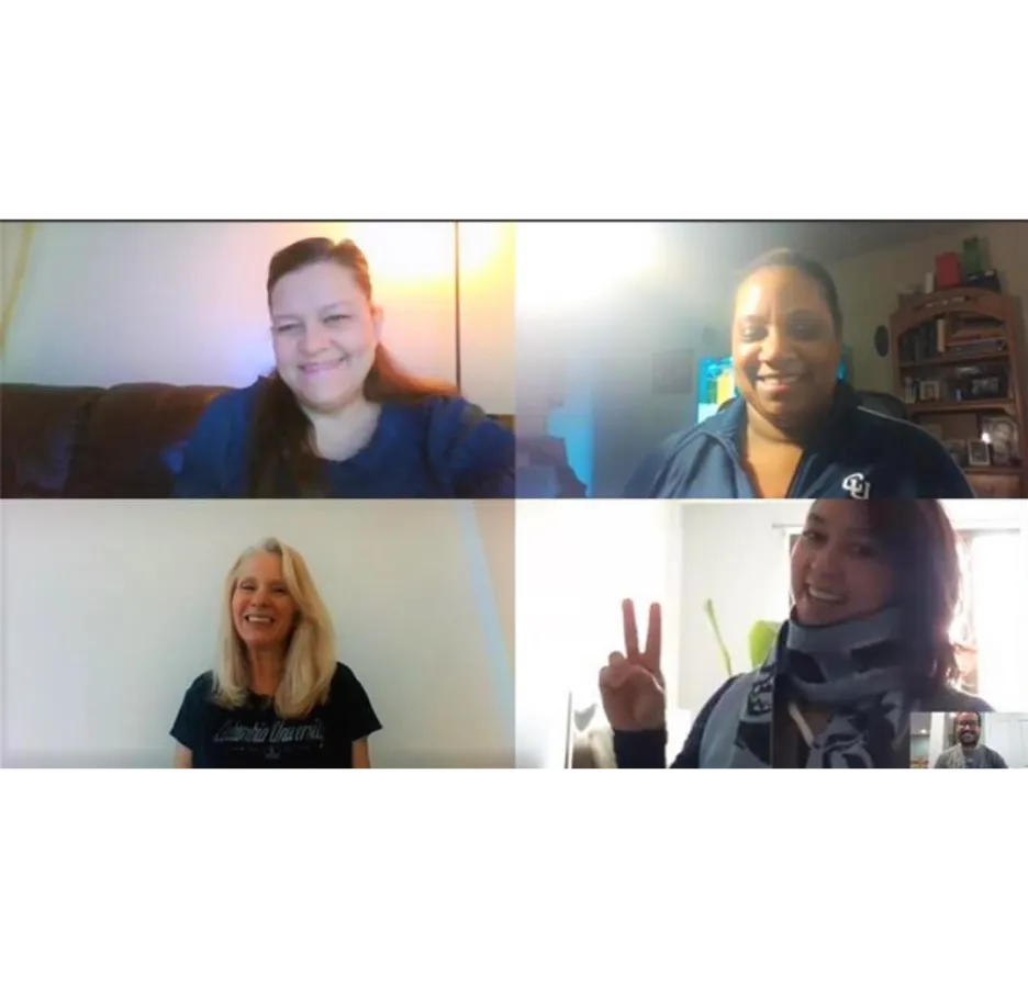 A screenshot of a video conference call showing five people smiling at the camera