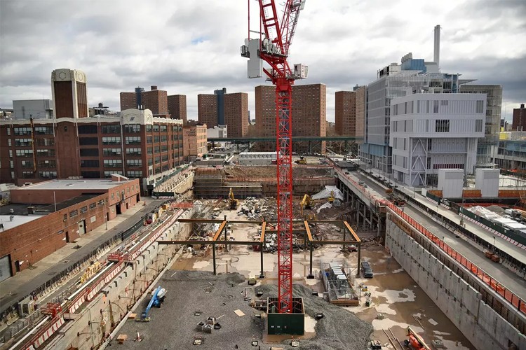 Construction site at Columbia's Manhattanville campus with a tall red consruction rig in the center of the phase two construction site.